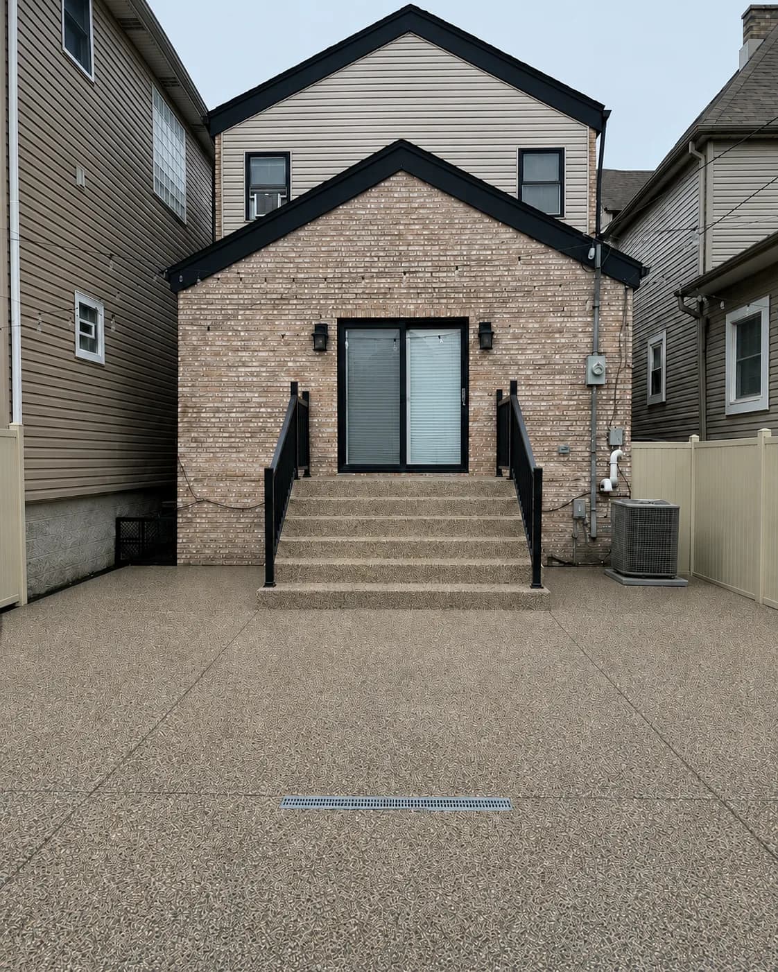 The same back patio and steps finished with a tan flake concrete coating